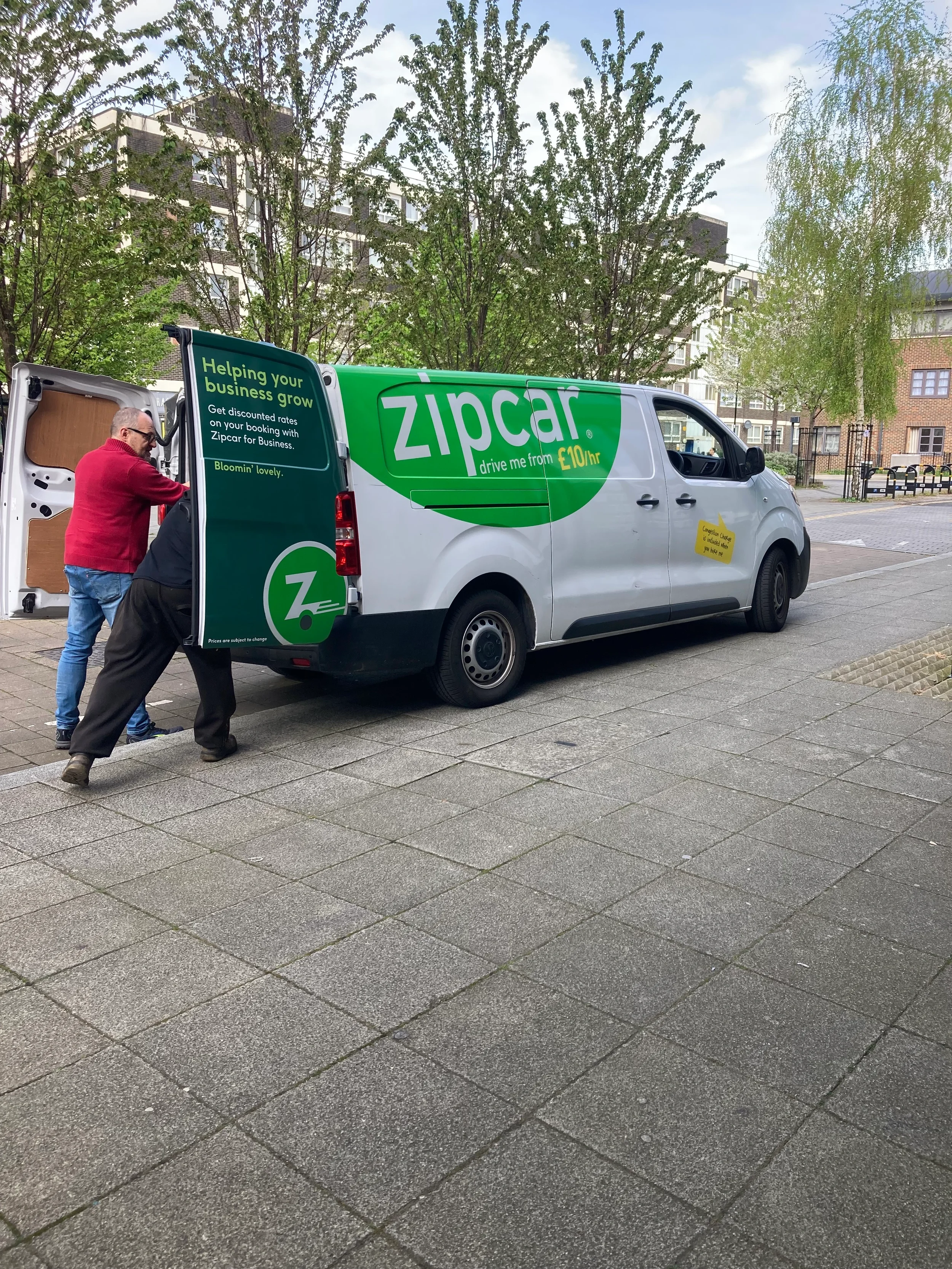Volunteer moving belongings into a zip van.