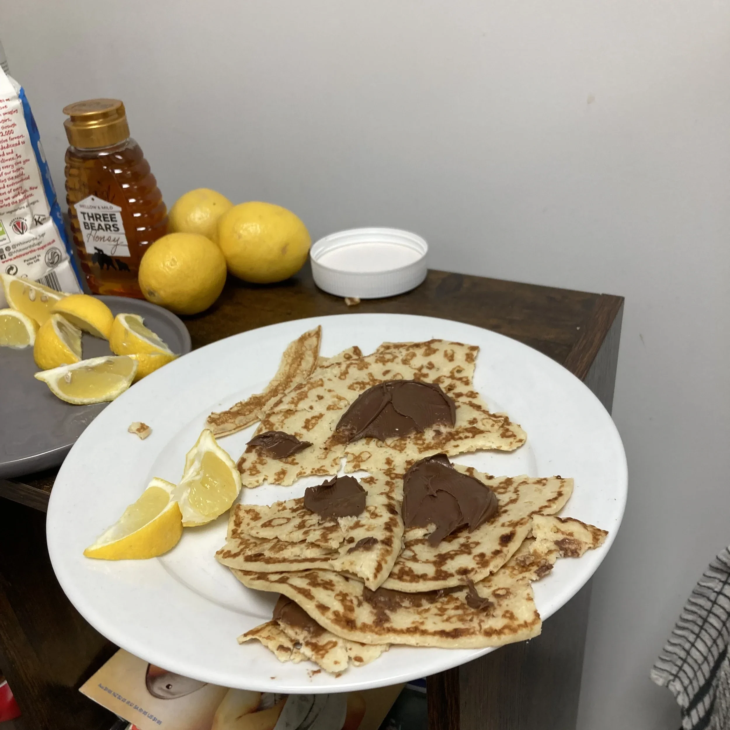 Pancakes with some lemon and Nutella on a surface in Street Storage.
