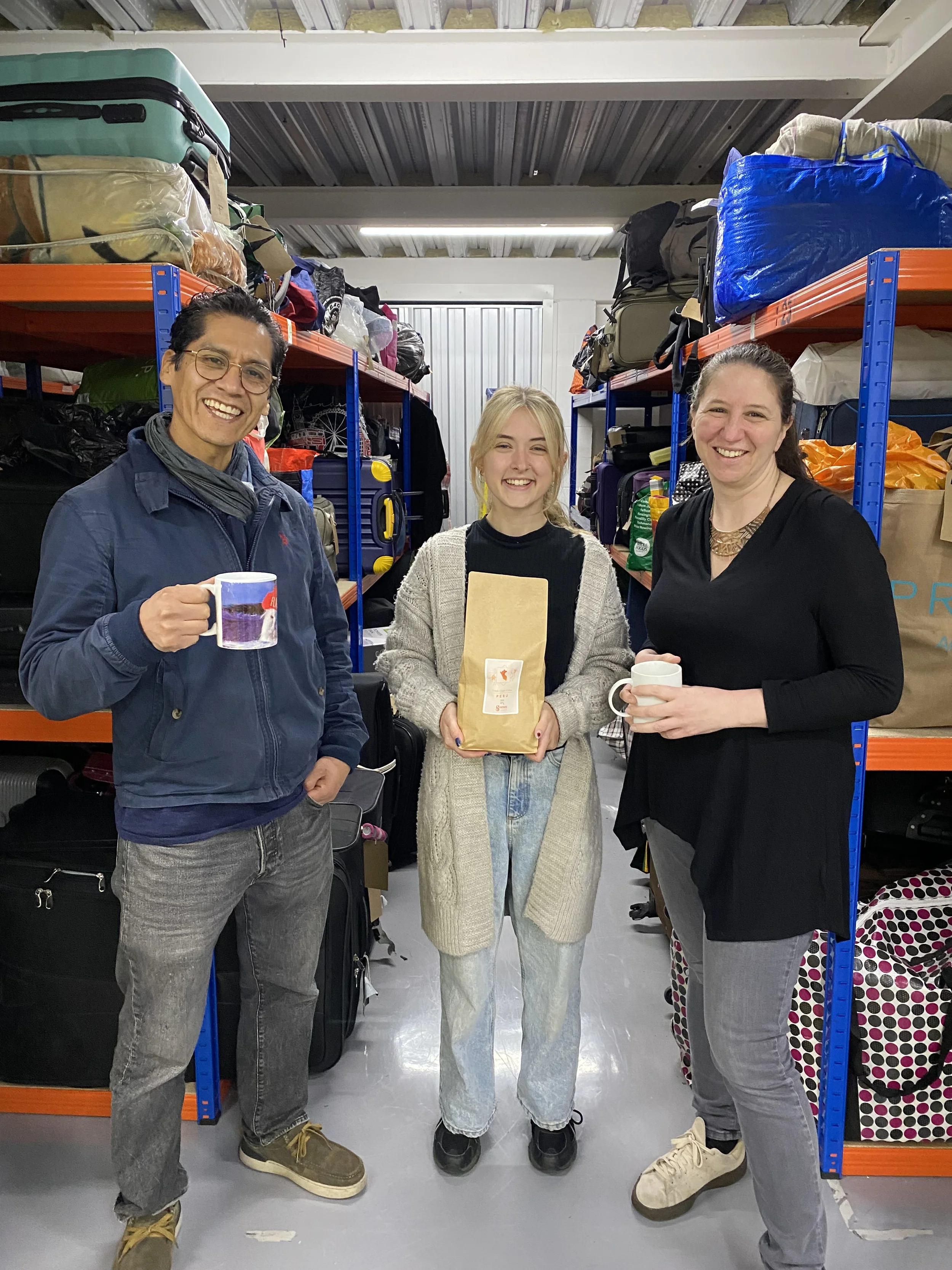 Lilian standing with the Founders of Gramos Coffee Charlotte and Rodolfo.