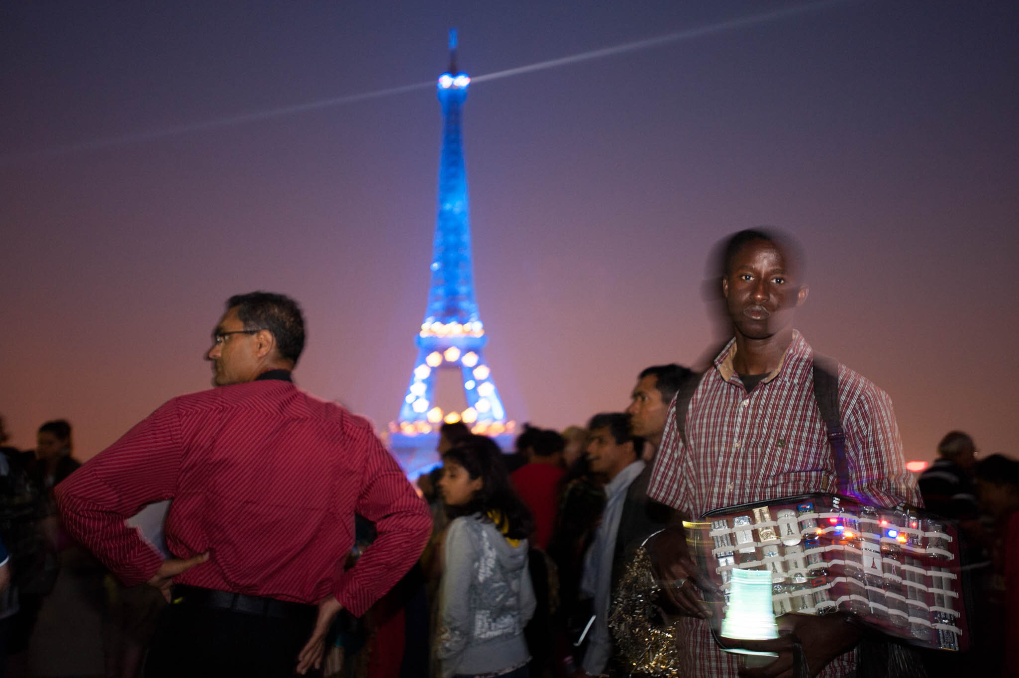    ‘Paris/NYC’ Book ‘Edition Lammerhuber’    Man selling tourist trinkets by Eiffel Tower. Trocadero 