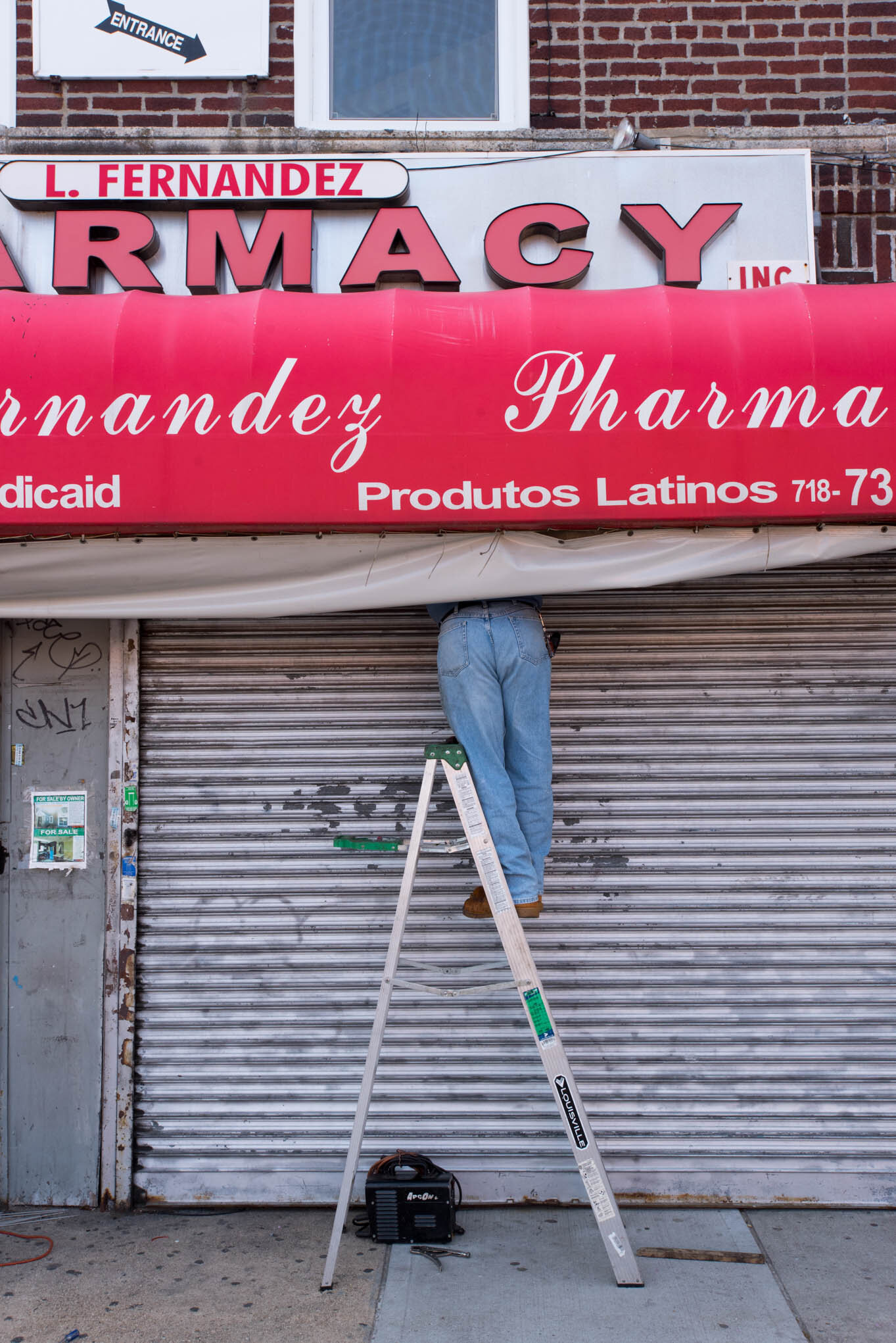    ‘Paris/NYC’ Book ‘Edition Lammerhuber’    Man fixing a storefront canopy. Ozone Park, Queens NYC 