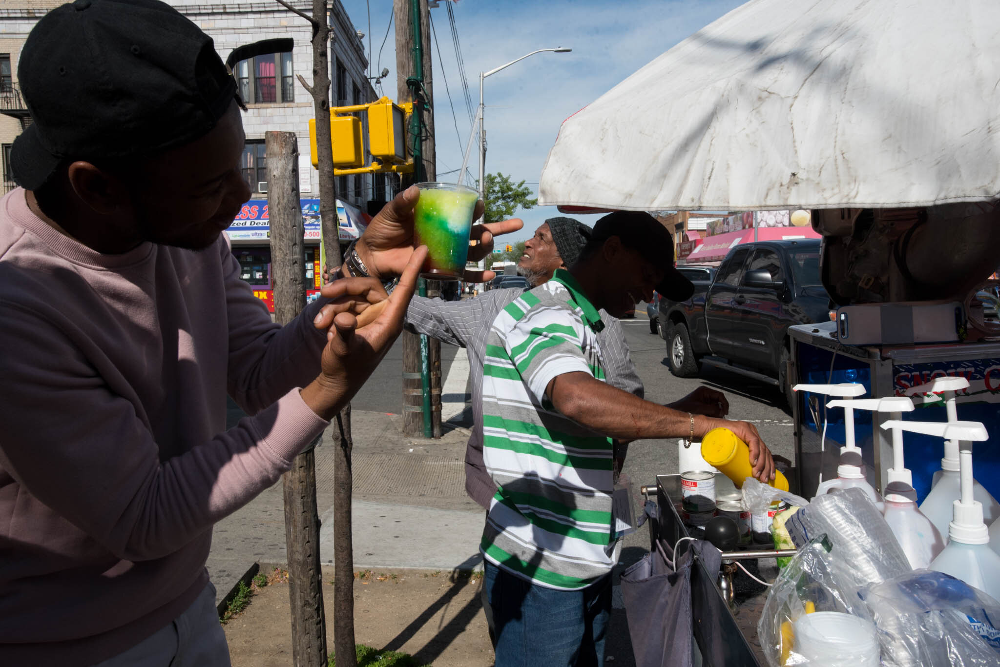    ‘Paris/NYC’ Book ‘Edition Lammerhuber’    Man selling flavored ice drinks. Ozone Park. Queens. 