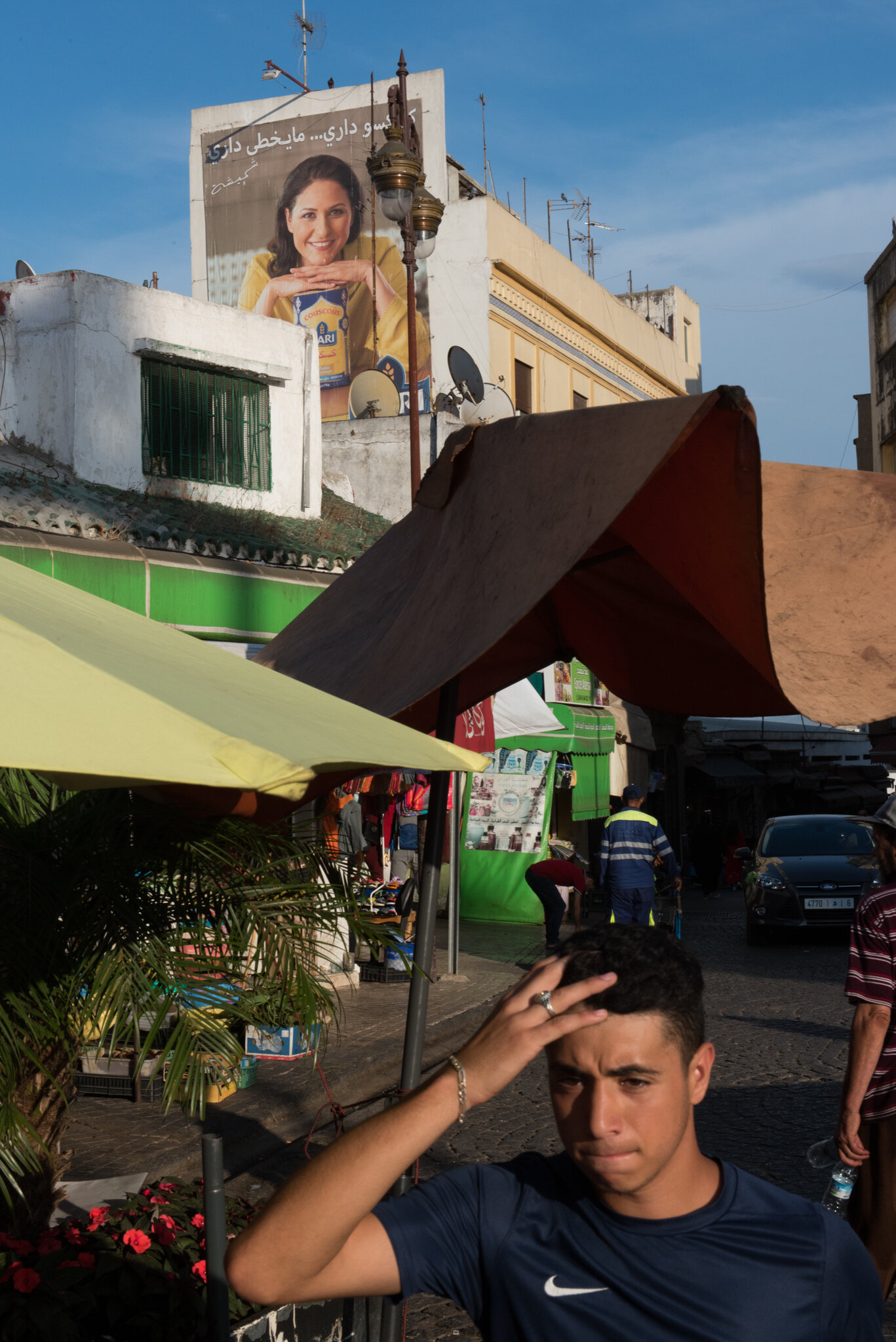    Morocco - Tanger    Street scene. Couscous ad in background 