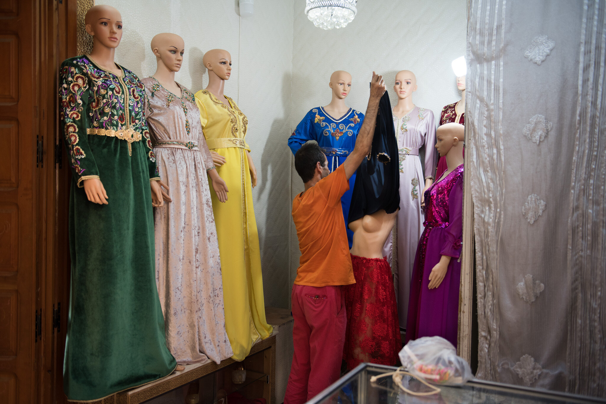    Morocco - Fes    Man changing mannequin dresses 