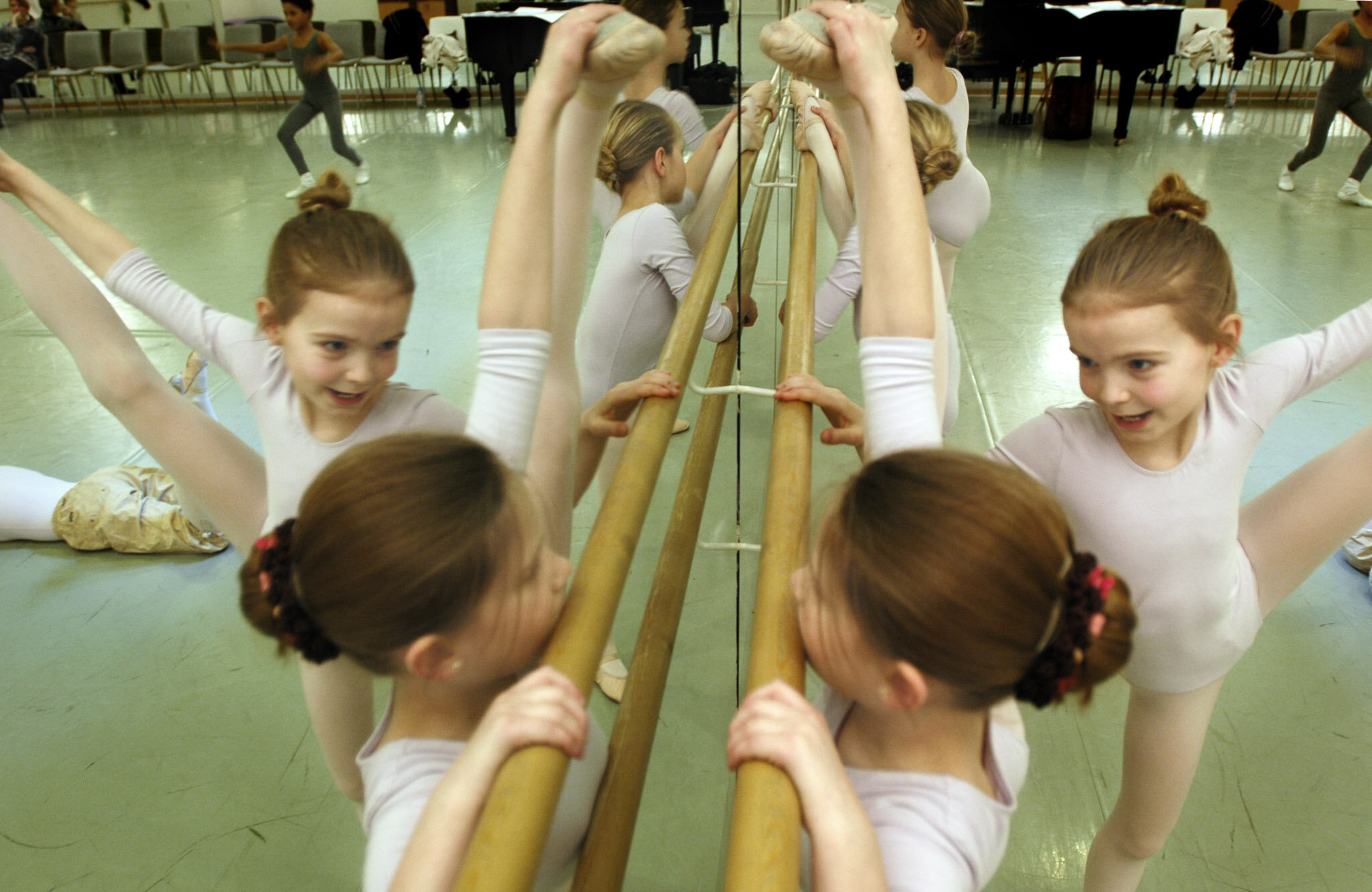    Children's ballet school, Holstebro Denmark    kids stretching next to mirror 
