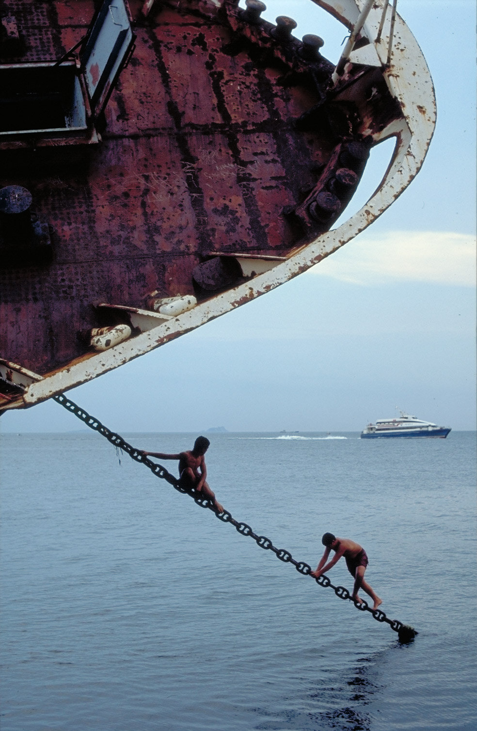    Istanbul, Turkey    Kids climbing on shipwrecked tanker boat.  