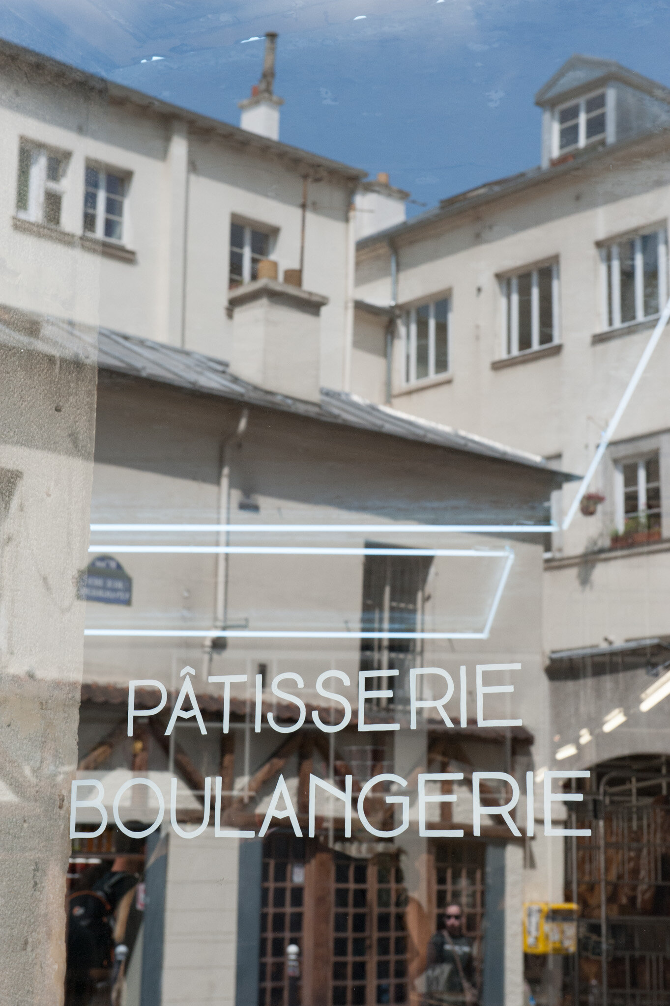    'Canal St. Martin' for National Geographic Traveler    Reflection in window of the boulangerie/pattiserie ‘Liberté’ 