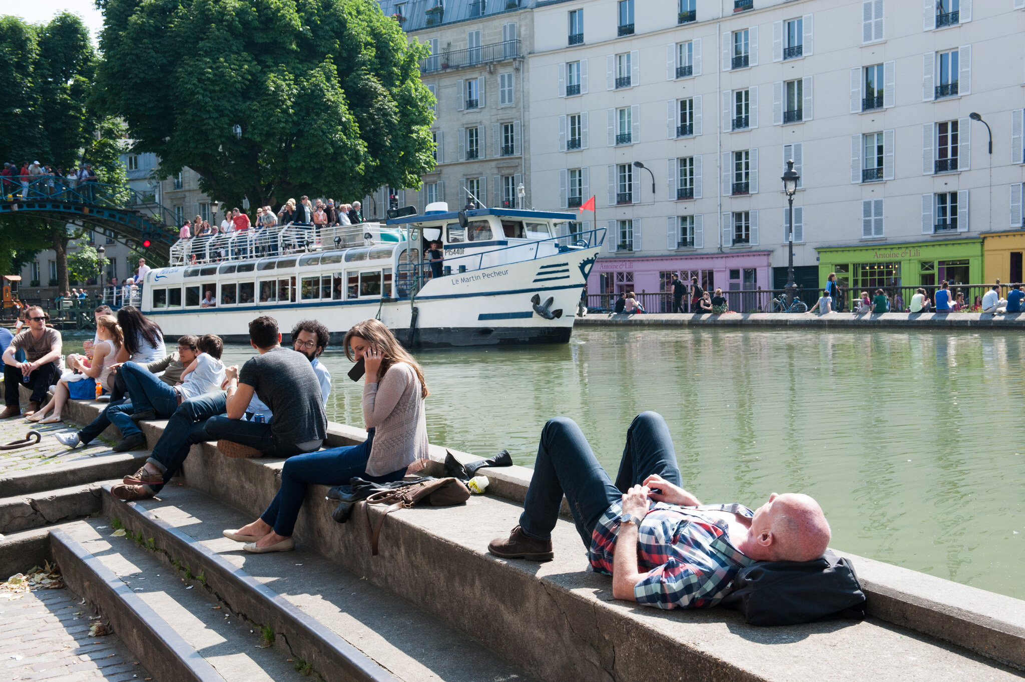    'Canal St. Martin' for National Geographic Traveler    People relaxing in the sun as boat passes by 