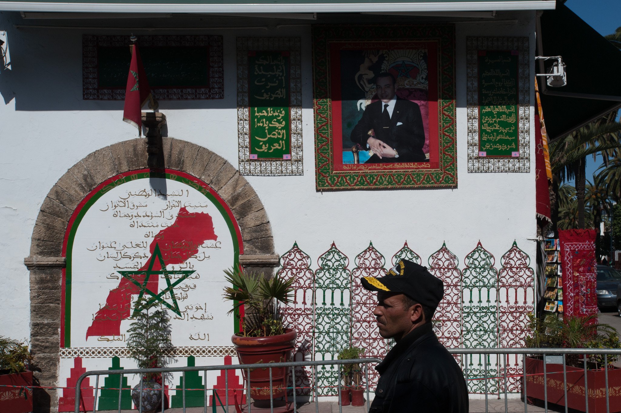    Morocco - Casablanca    Man walking by. Picture of king on wall. 