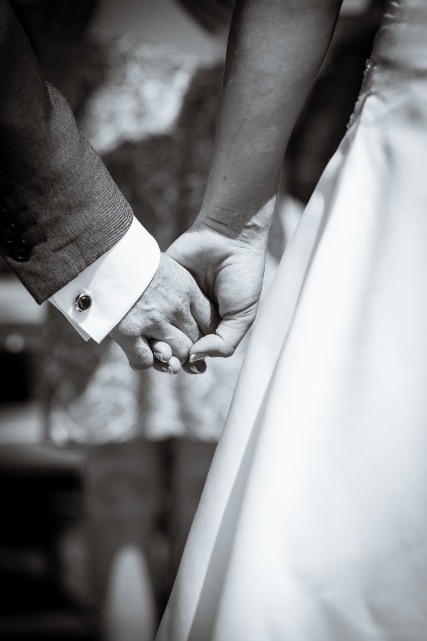  Close-up of the couple holding hands in mono. 