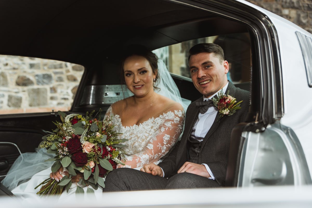  bride and groom in limo 