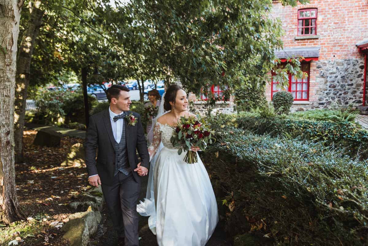  A couple walking along the path looking at the venue happy they decided to book the venue for their reception. 