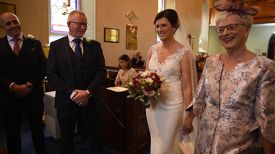  The groom looks around as the bride walks up the aisle in the ceremony in Edenderry and Clanabogan Church of Ireland in Omagh. 