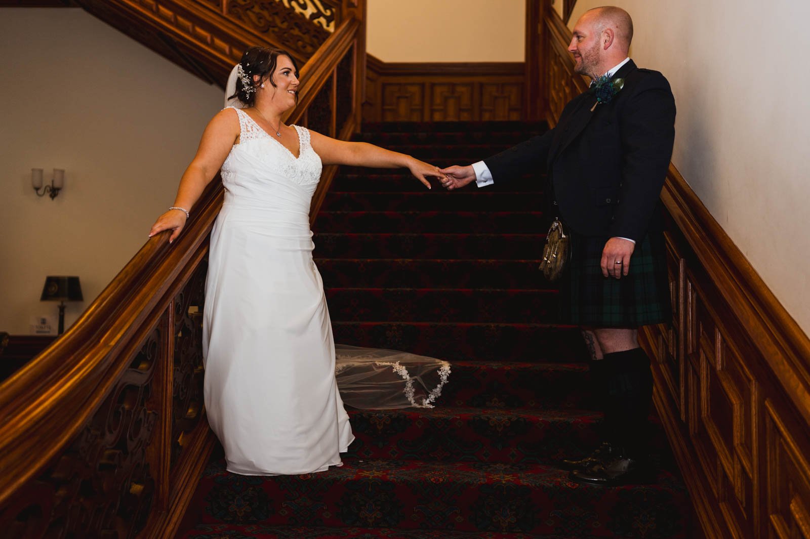  bride and groom on stairs inside 