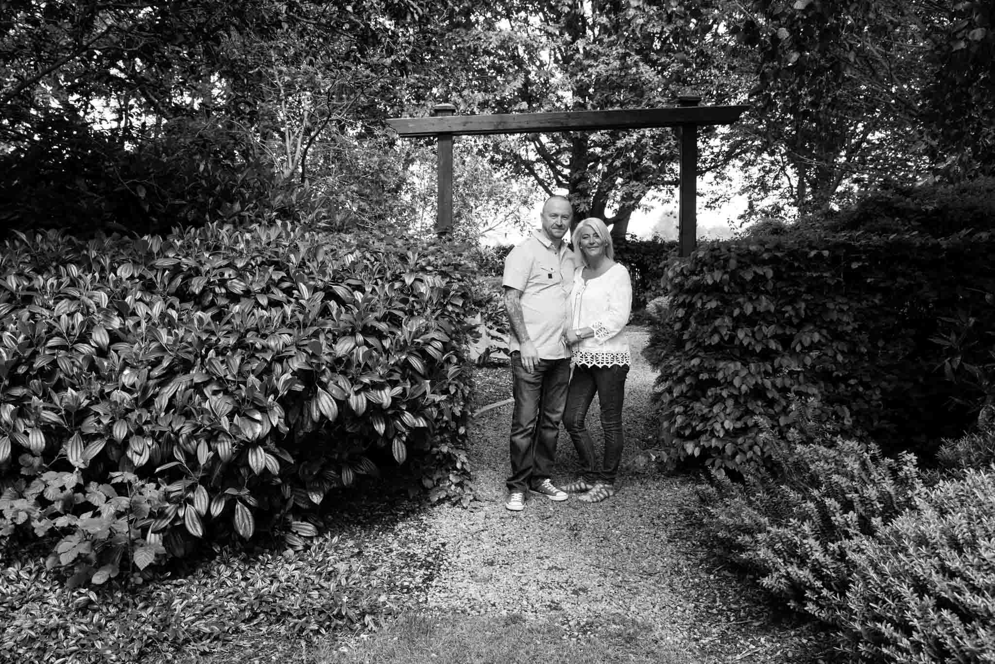  Mono image of a surprise photo shoot with the couple under the archway. 