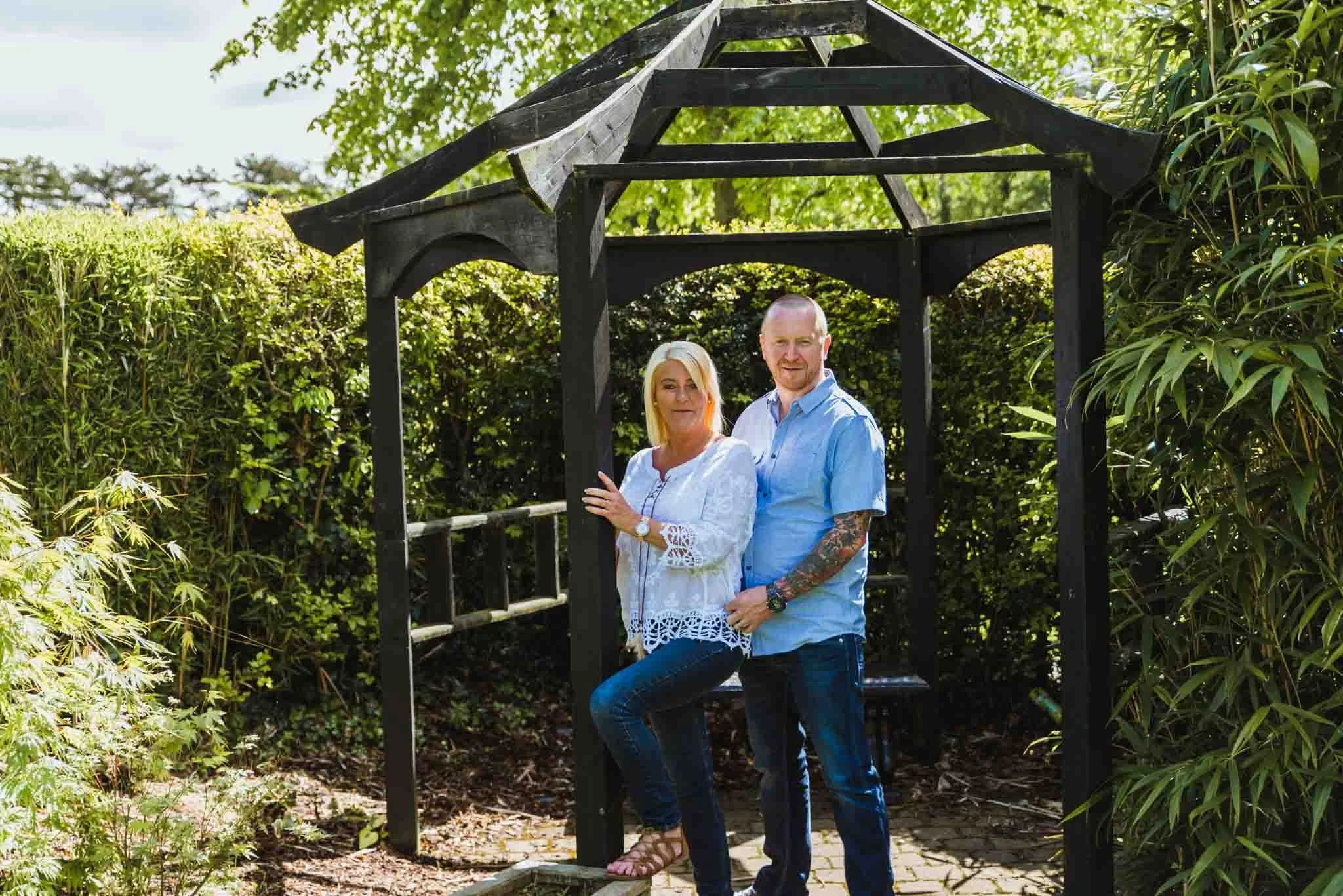  The couple was standing beside each other under a wooden hut. 
