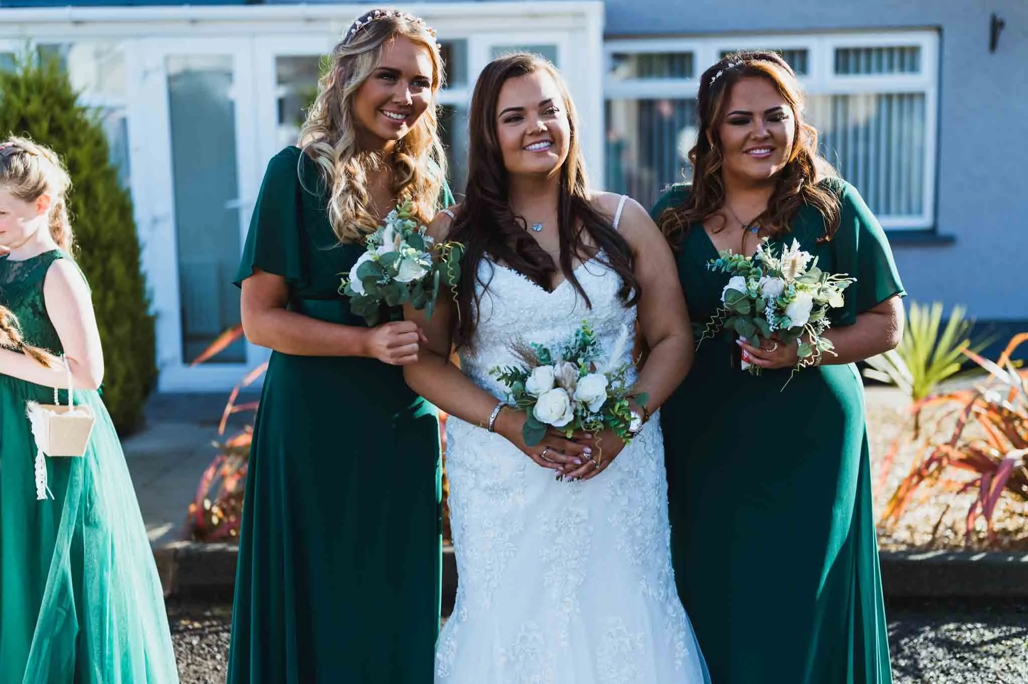 Bride with bridesmaids holding bouquets.
