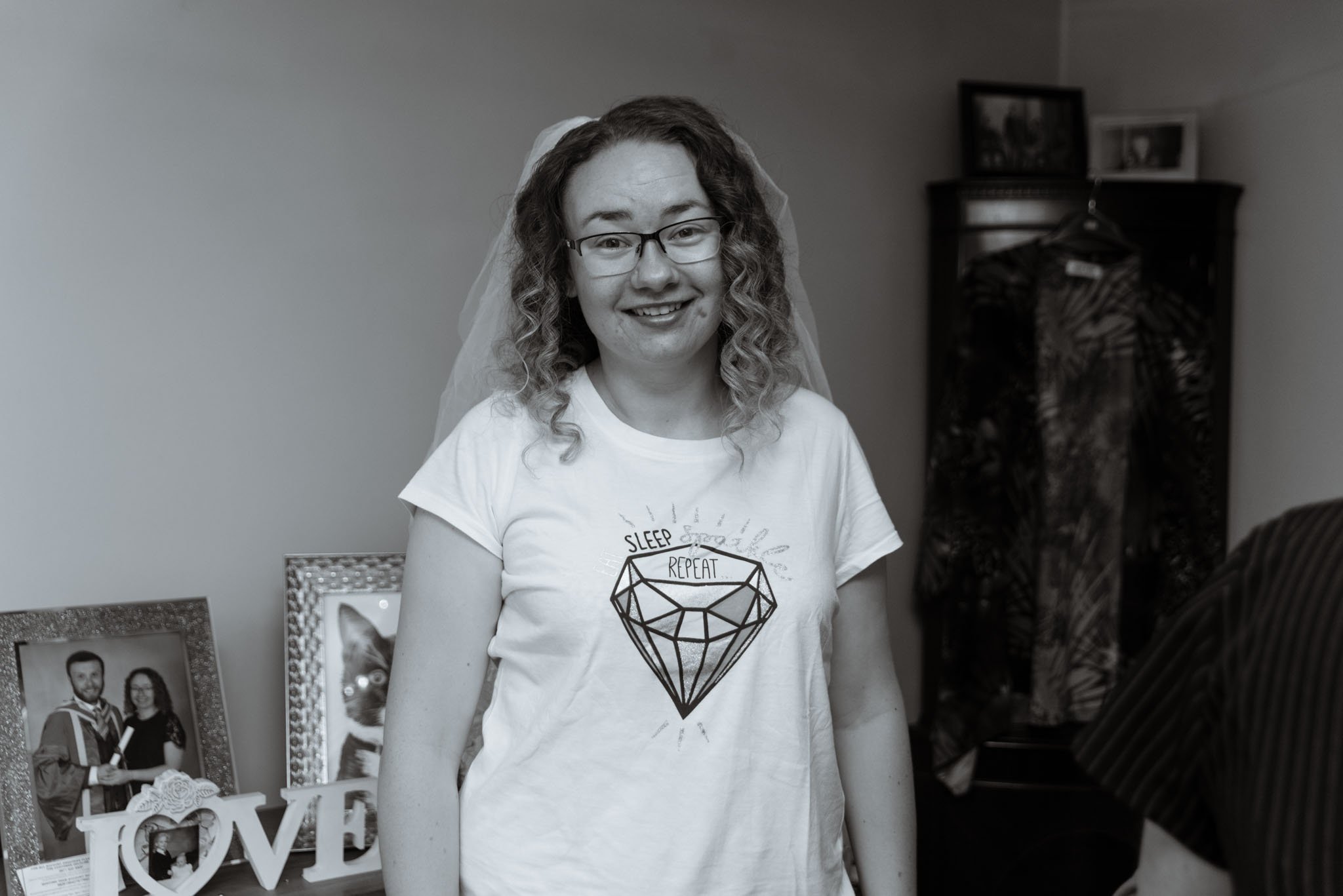 Mono photo of the casual bride with veil and pyjamas.