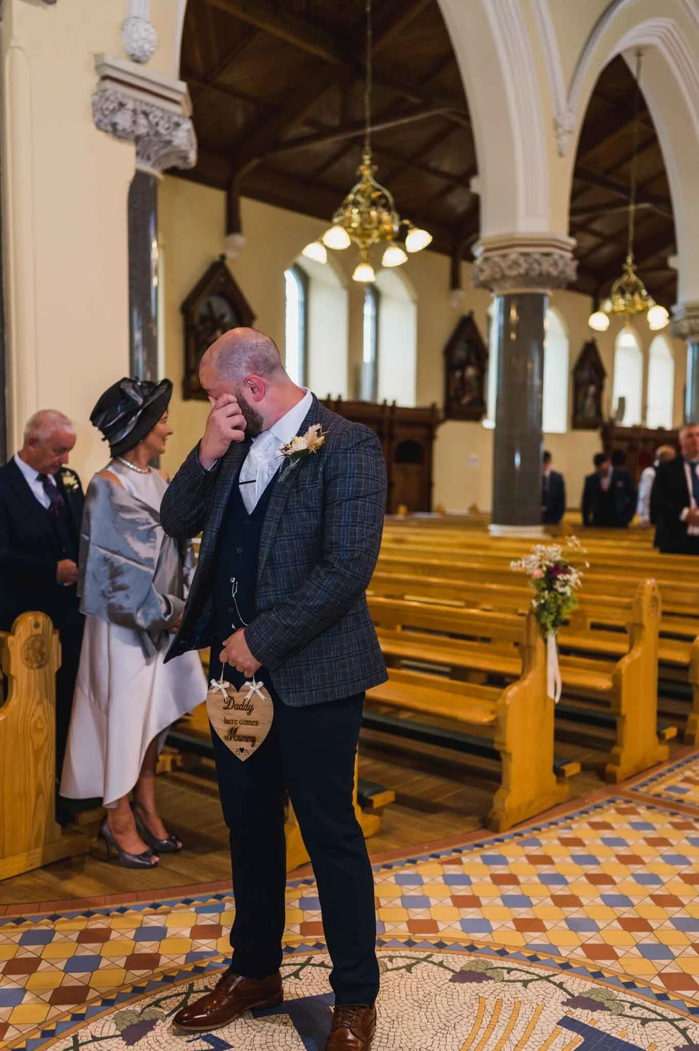 Groom crying at the front of the Church waiting on bride.