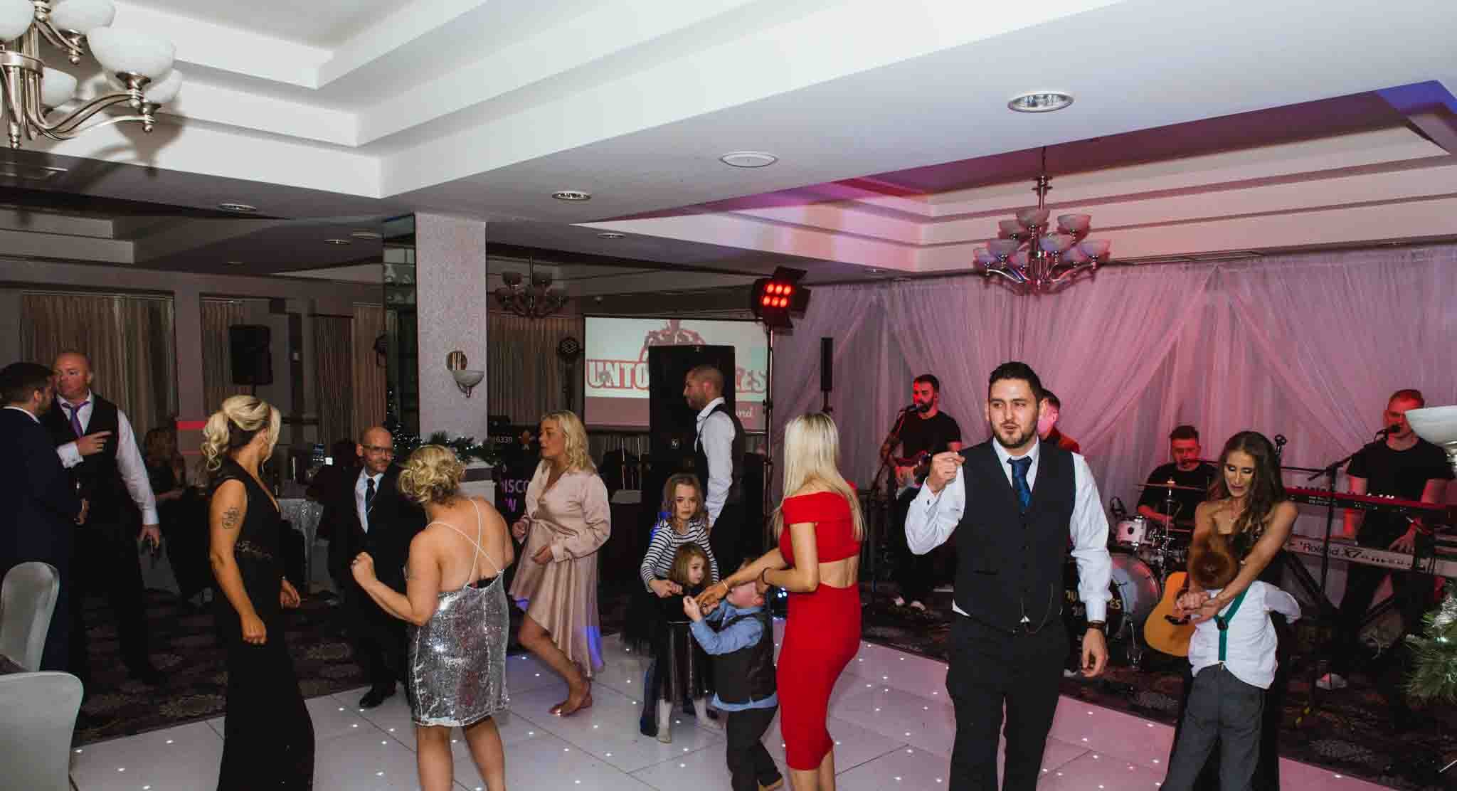 Guests are dancing in the reception on the dance floor.