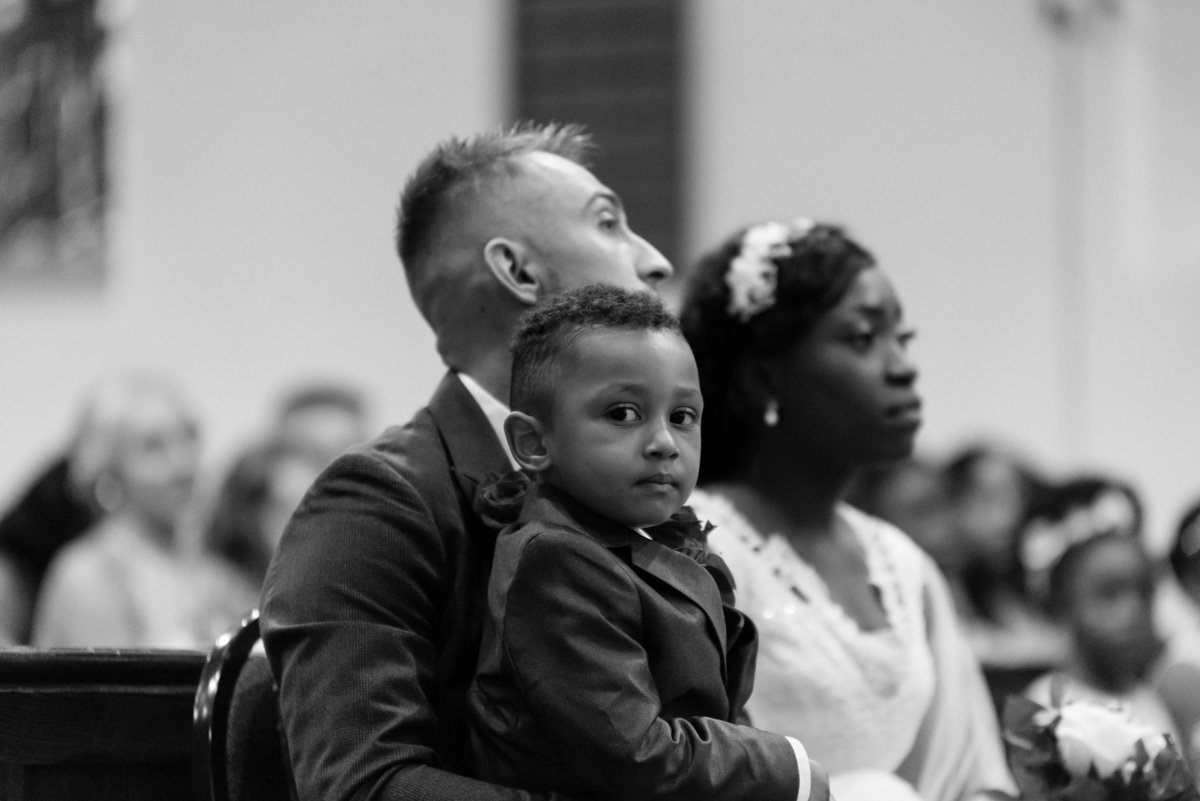 Mono photo of their child sitting on fathers lap.