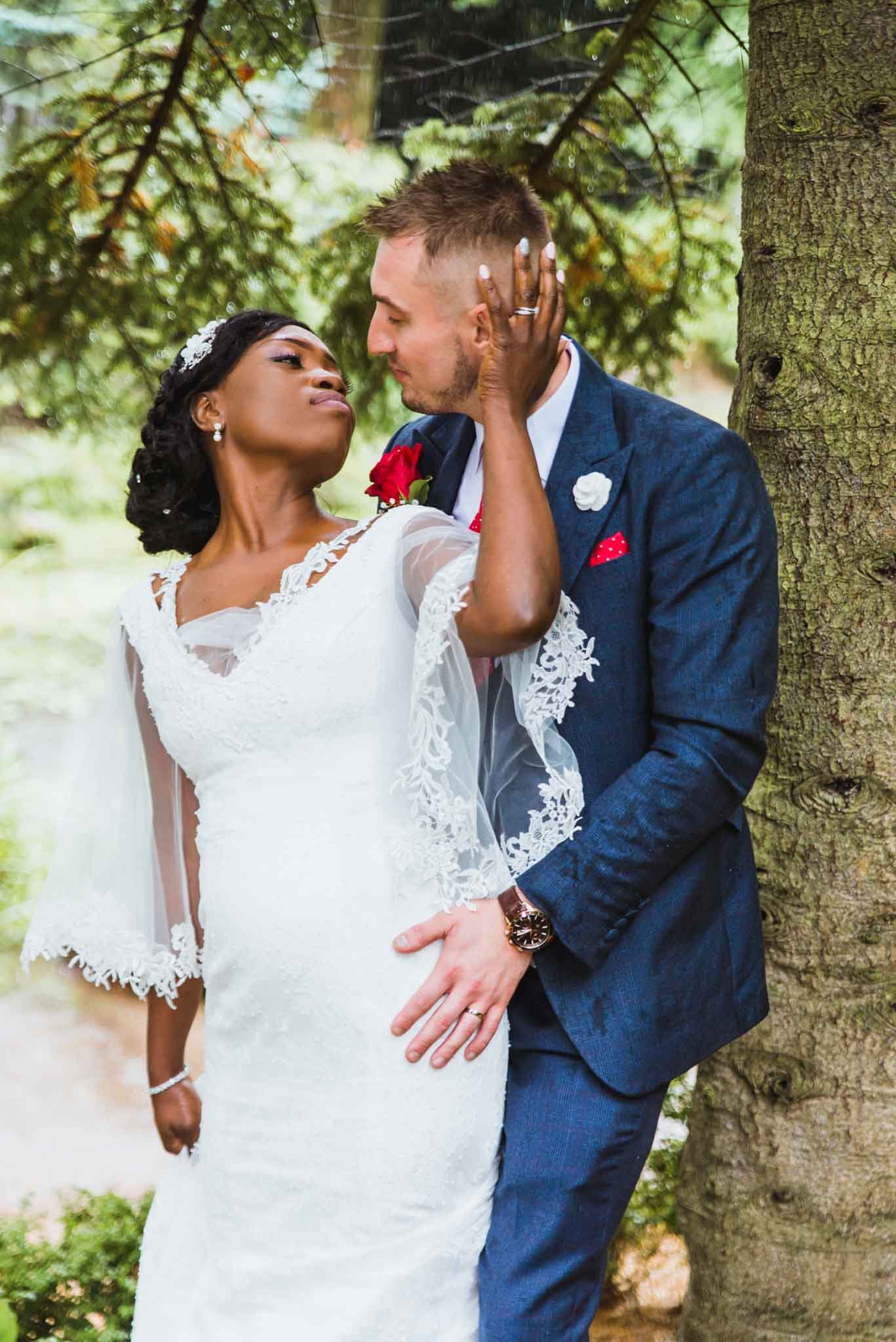 Romantic photo of the bride touching the groom's cheek, looking into each other's eyes in love.