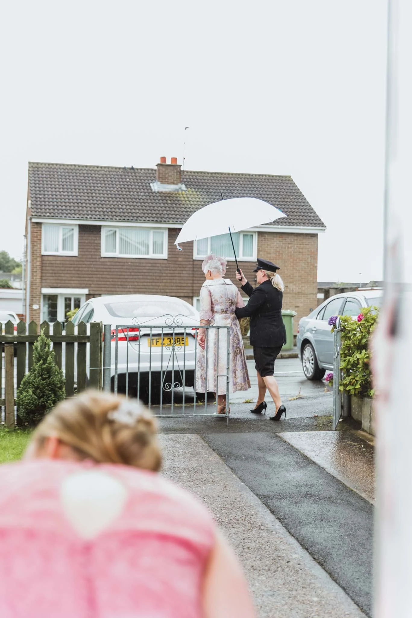 Angel Wedding Cars is helping the mother of the bride out to the car in Killicomaine Estate.
