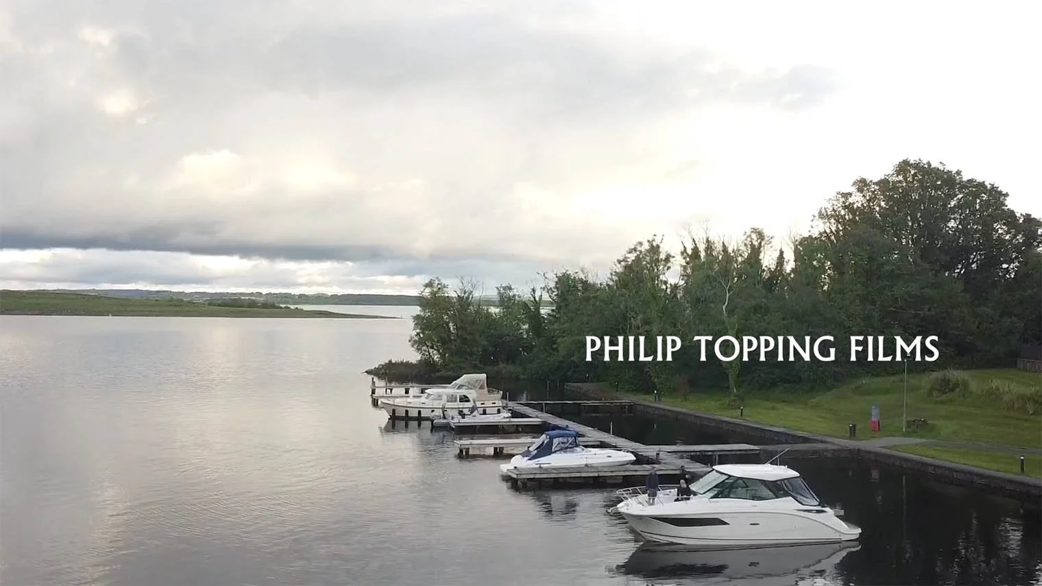 Outside, with boats and yachts moored up at the shore.