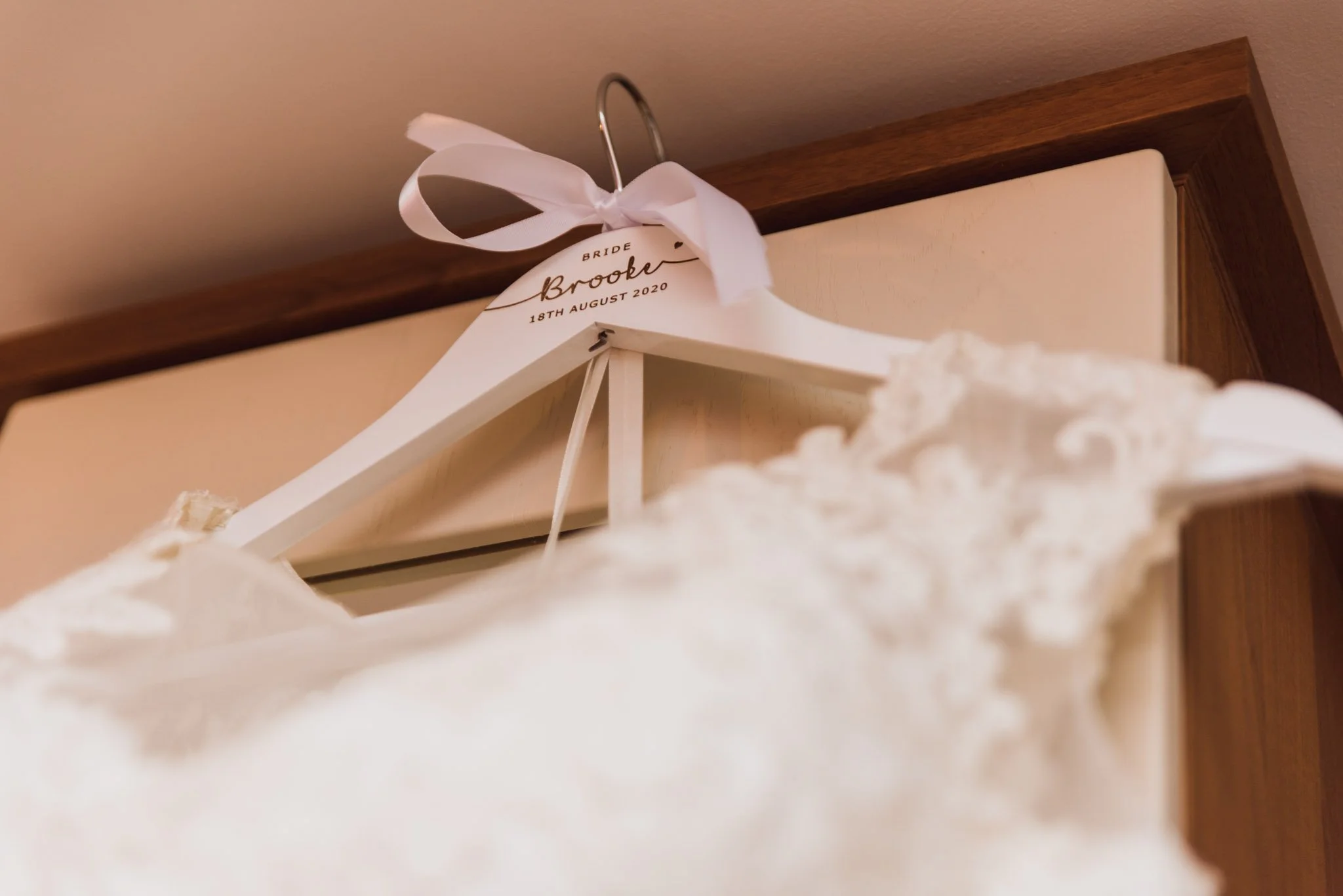 The bride's dress was hanging up on the wardrobe, supplied by Orchid Bridal Studio in Bridge Street.