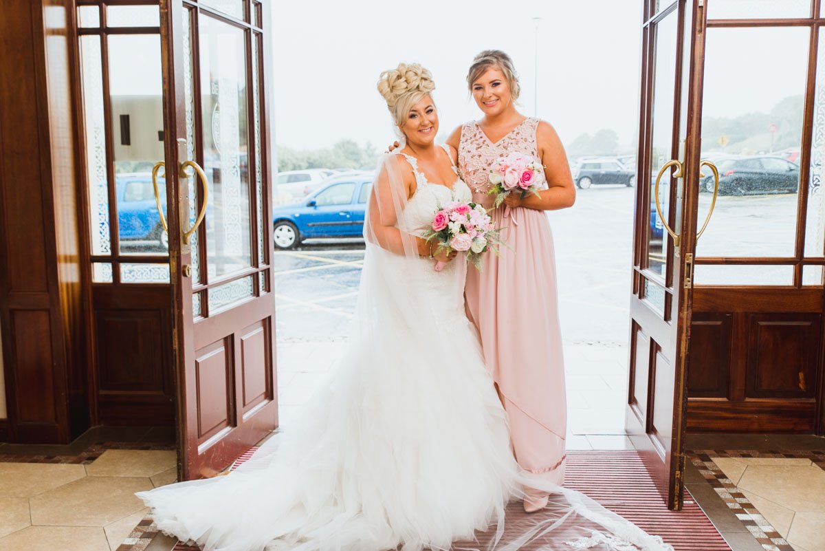 Bride and maid of honour at the entrance of Carrickdale Hotel.