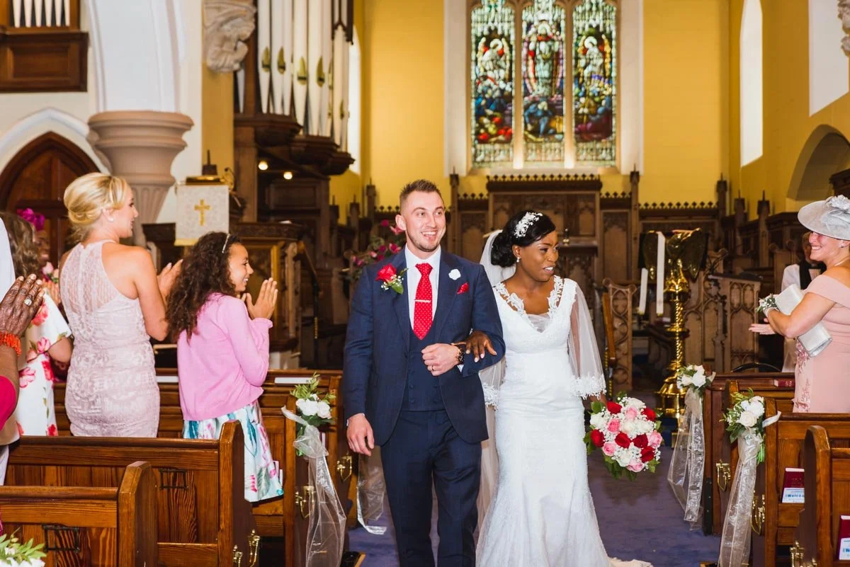 Birde and groom walking down the aisle.