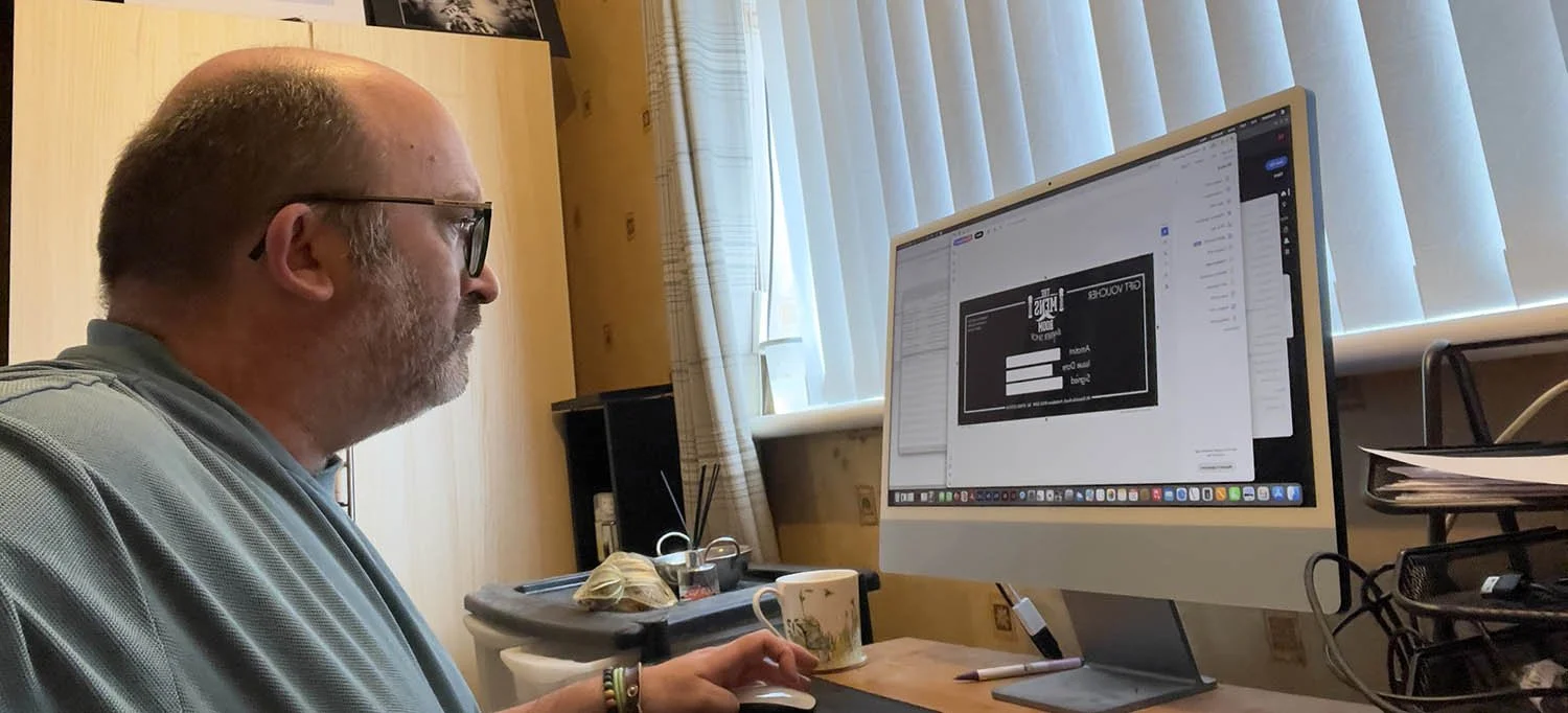 Pre-press expert checking artwork on the Apple Mac before printing.