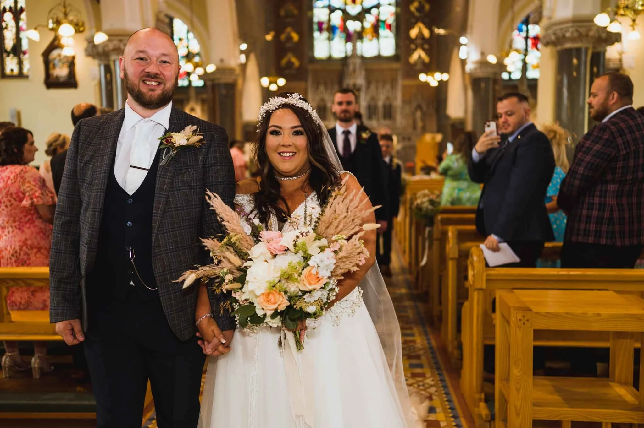 Husband and wife walking down the aisle.
