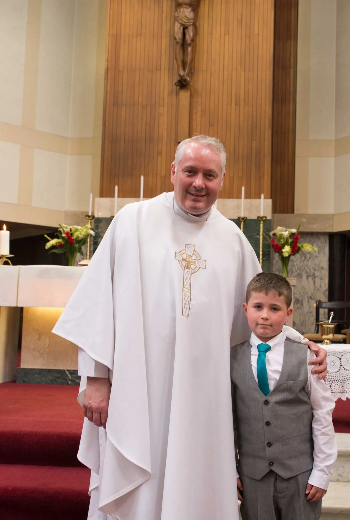 Priest with young male at the front after the communion.
