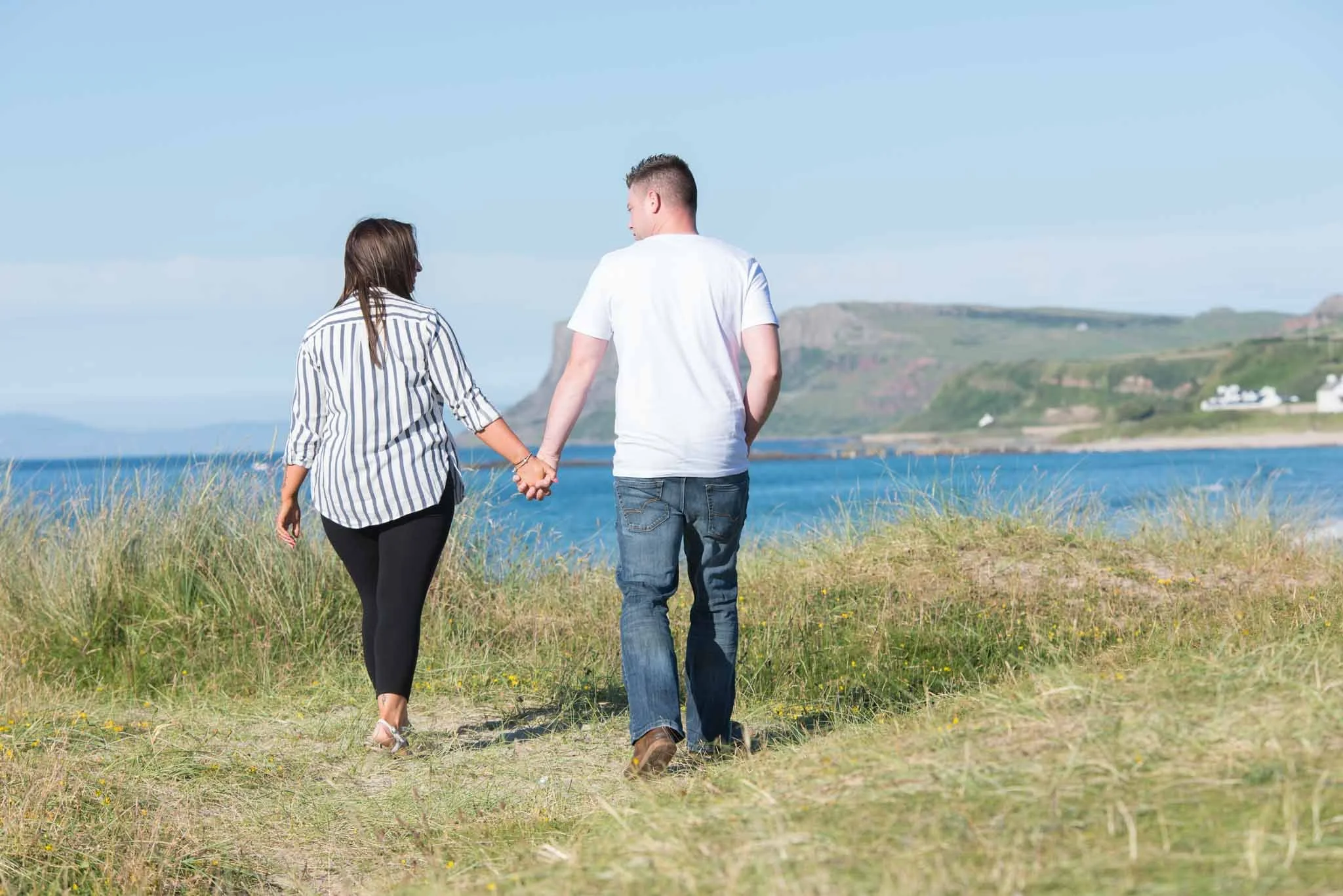 The couple walk along the famous location, the North Coast.