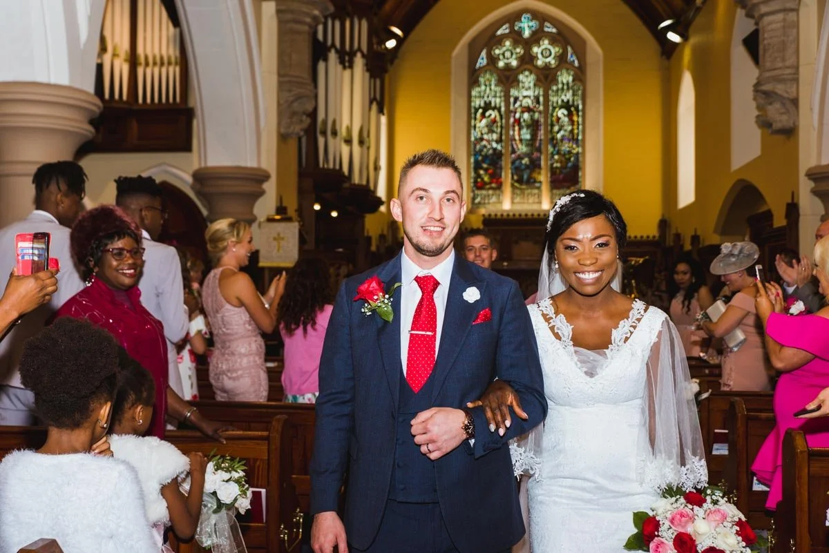 Closer photo of the bride and groom walking down the aisle after marriage.
