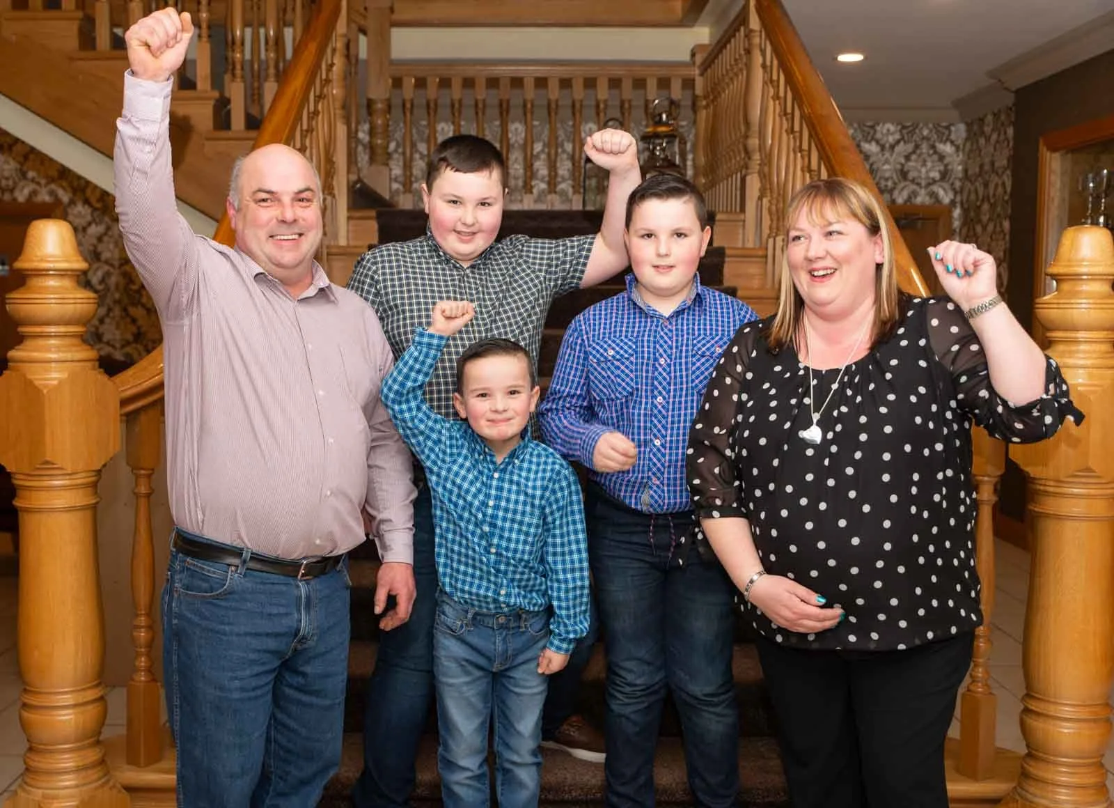 James Tinsley and his family are at the bottom of the stairs.