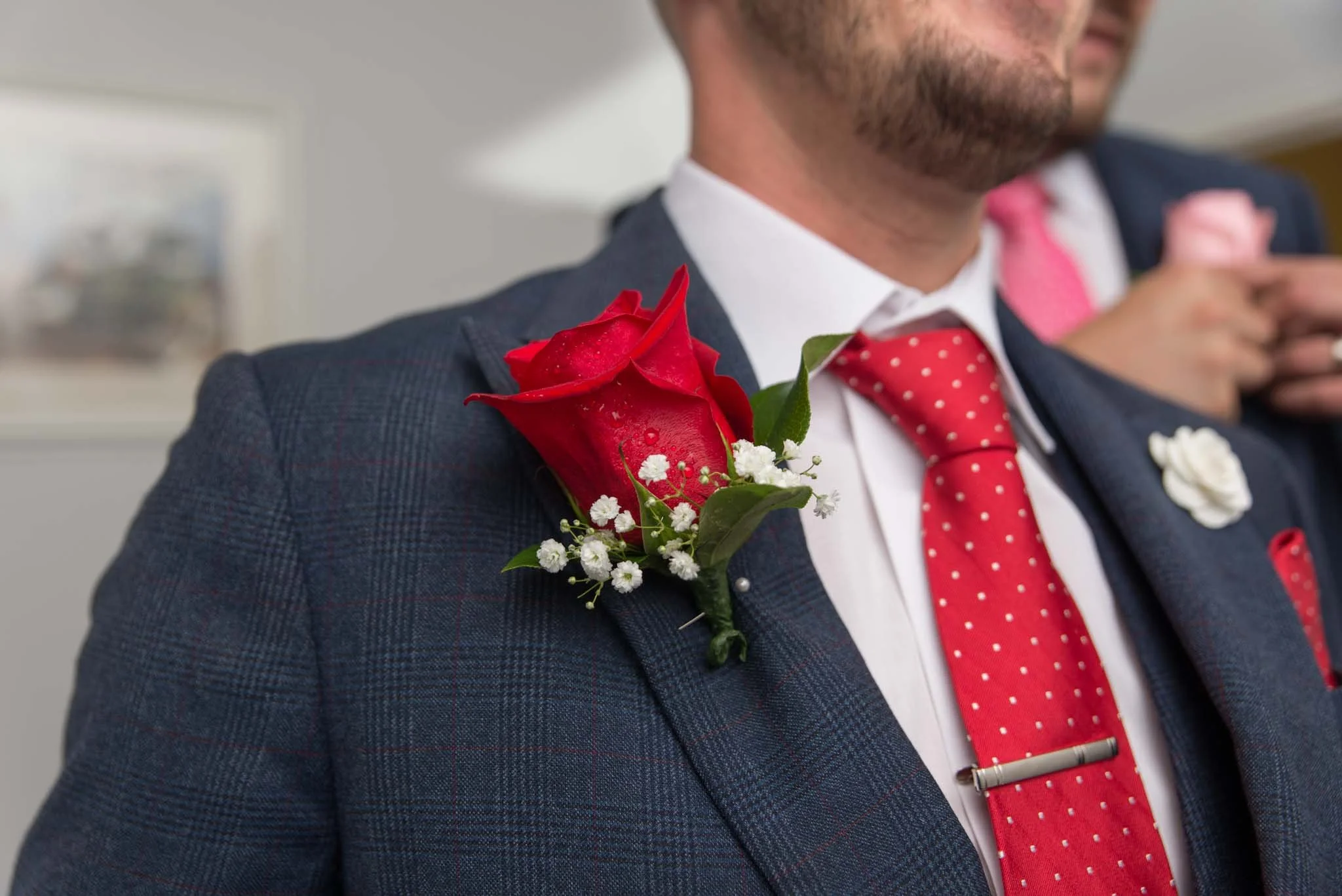 Close up of the groom's flower on his jacket.