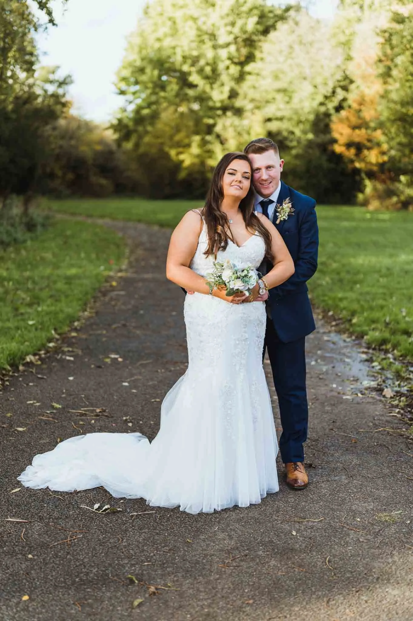 Bride and groom portrait on a path.