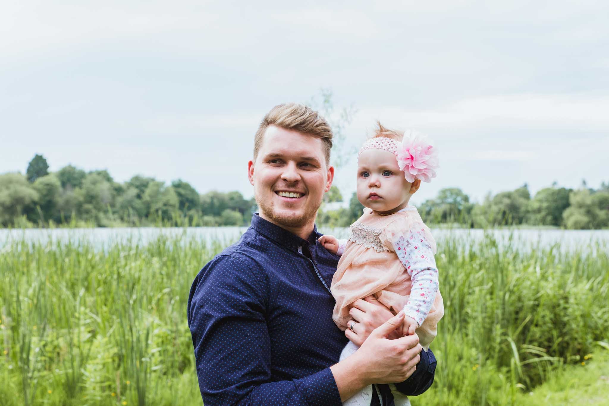 Dad is holding the baby.