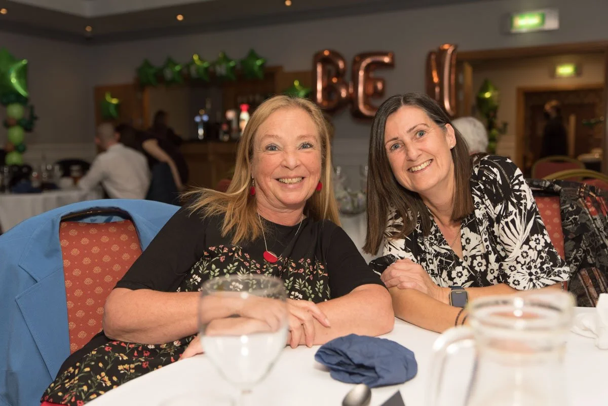 Two guests at their table are attending the party.