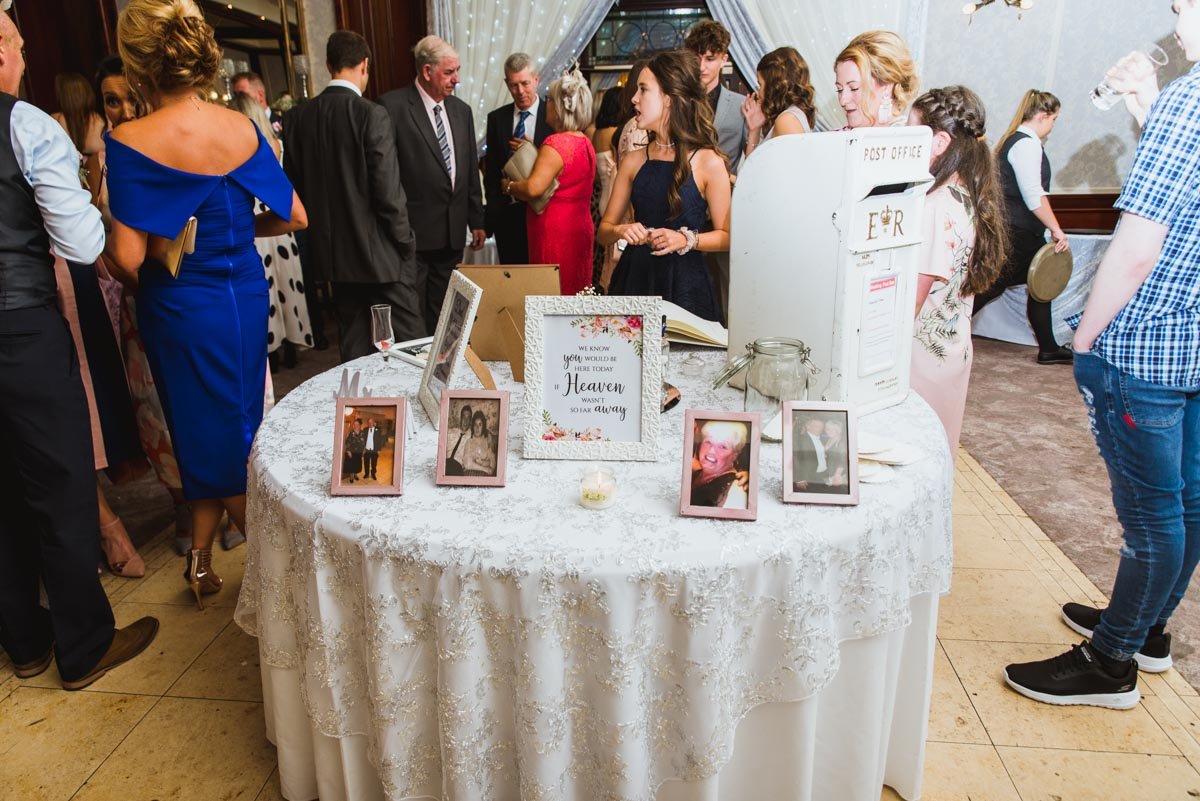 Guests are around the table at the entrance of the venue.