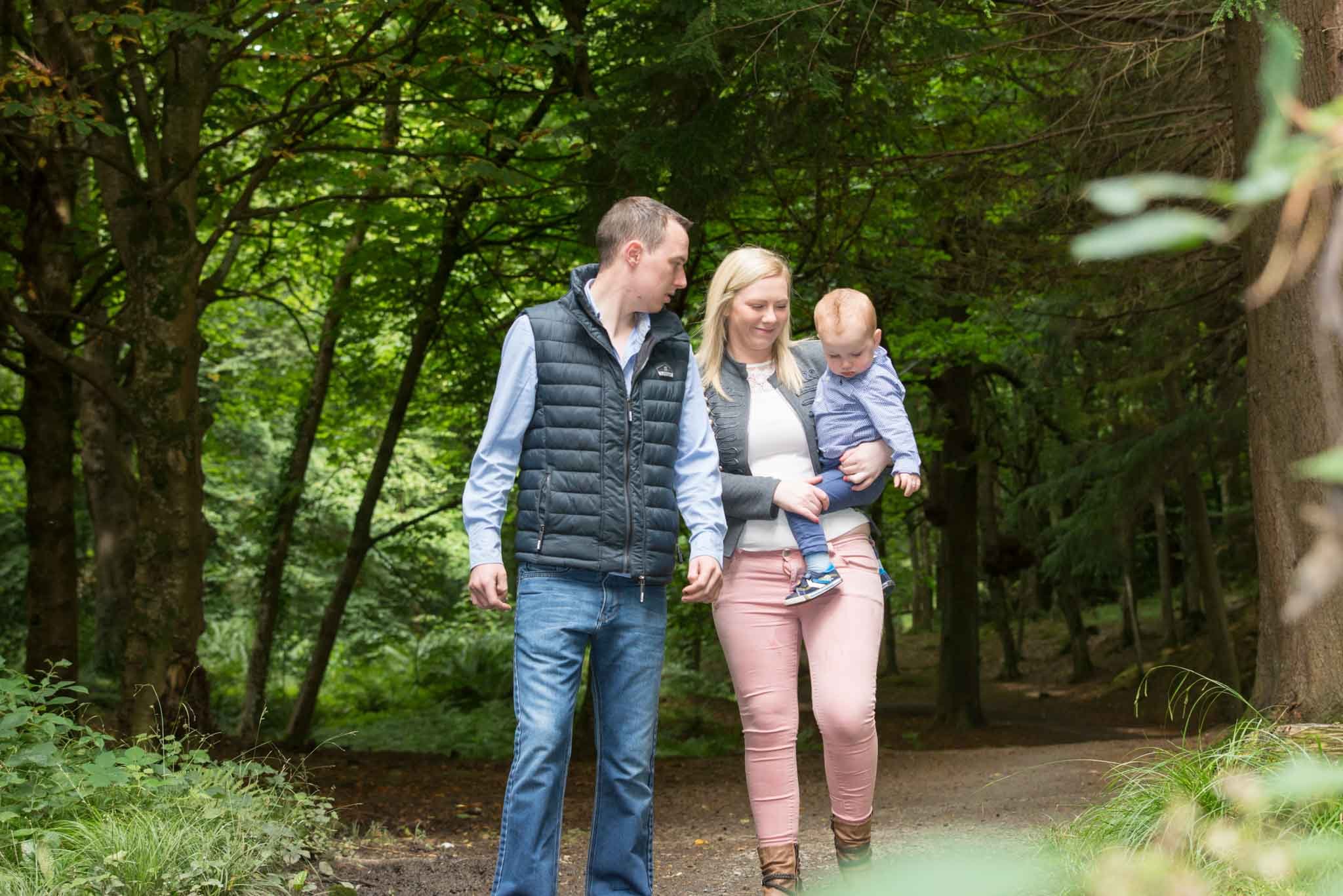 A family walking with a mum carrying a son.