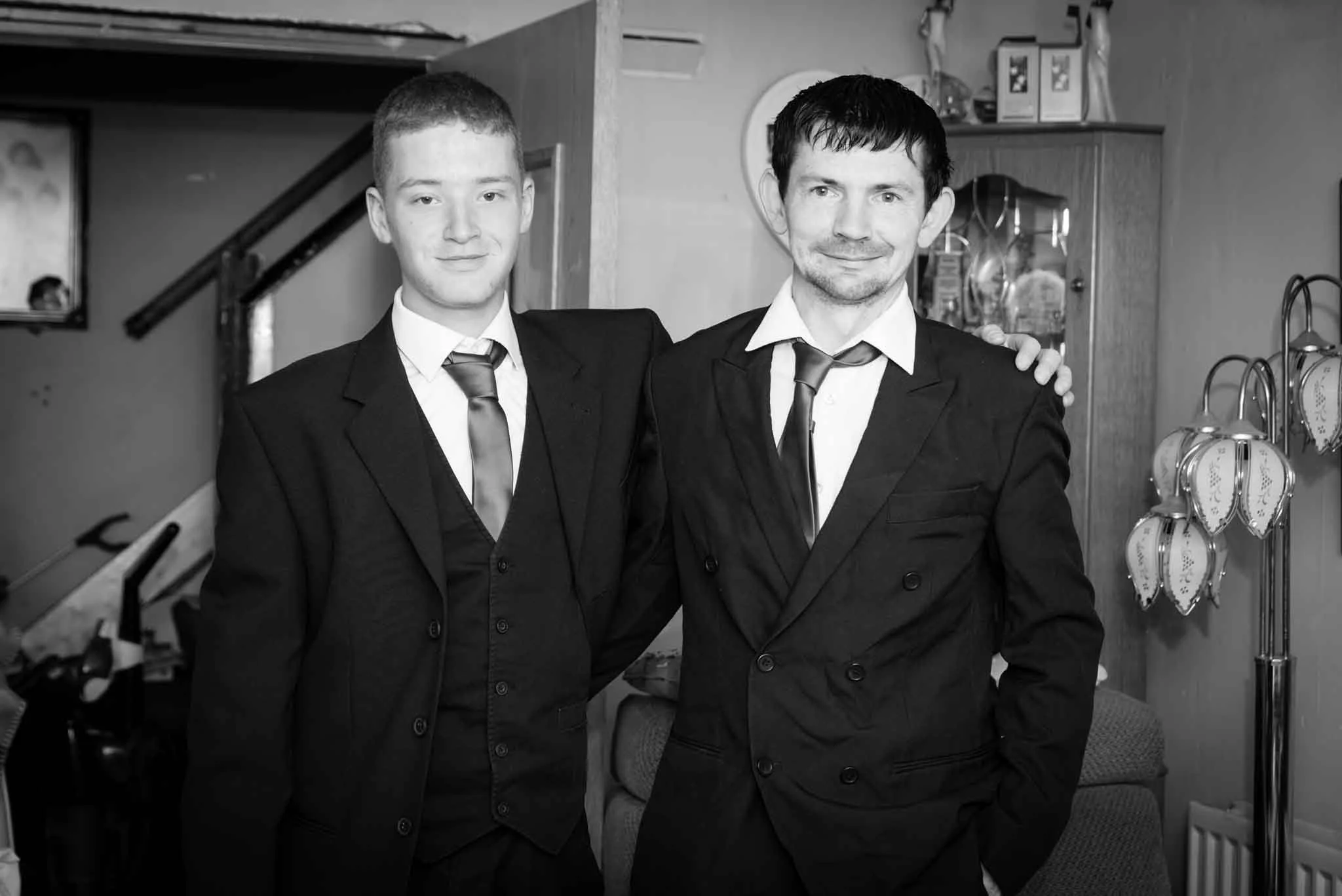 A black and white picture I photographed in the living room with the groom and groomsman, who are brothers.