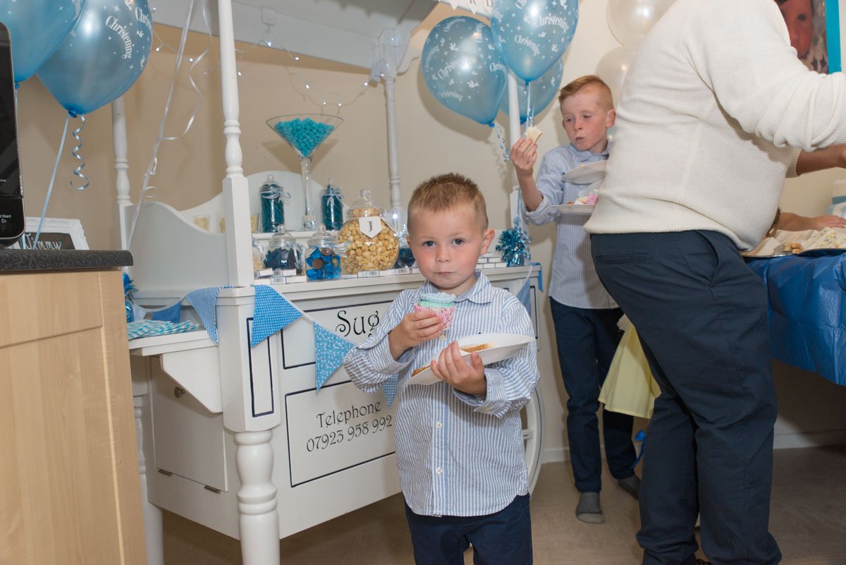 Young child celebrating in kitchen.