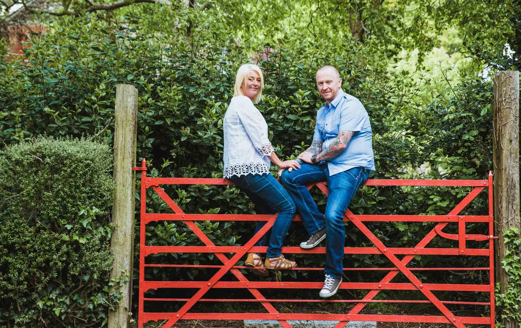 Sitting on the red gate.