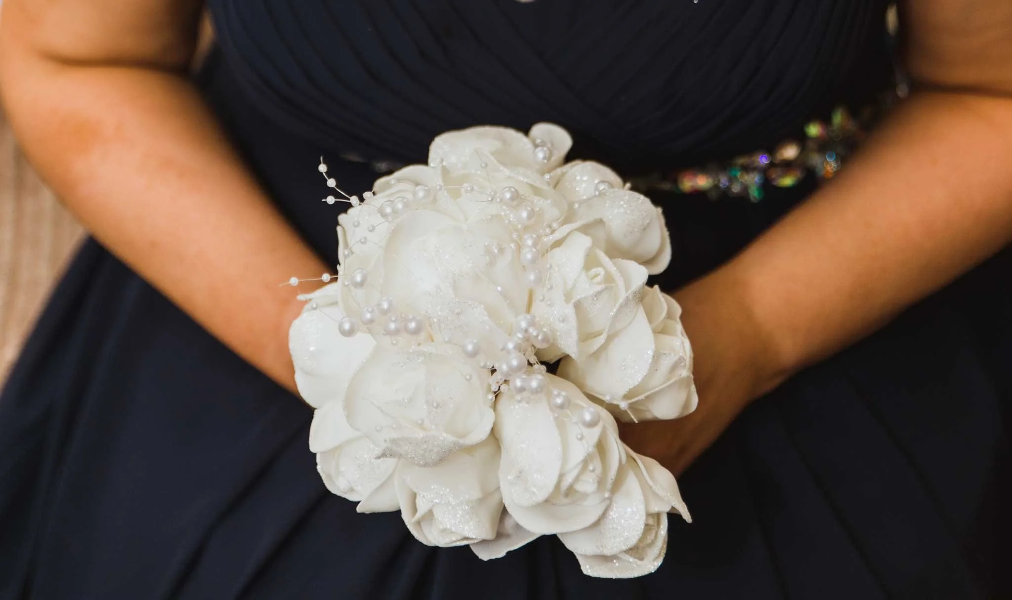 Close-up of the bridesmaid holding a bouquet.
