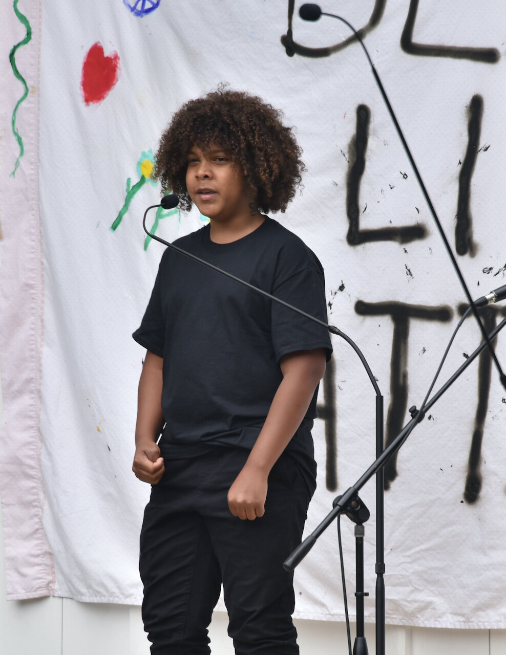 Rising ninth grader Damien Garcia speaks at his second rally in a week, this time addressing his hometown. Photo by Gordon Miller.