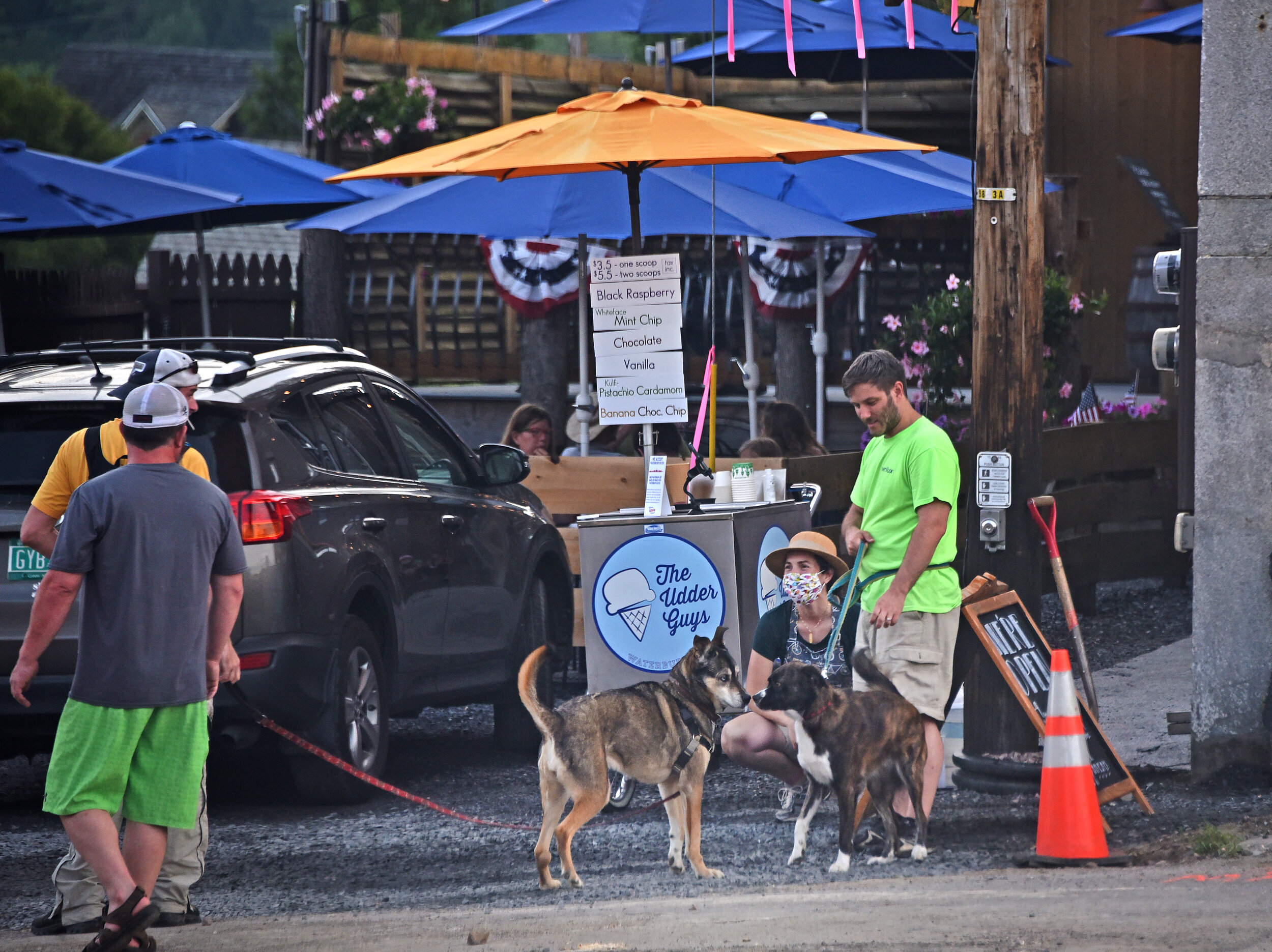   Two- and four-legged customers enjoy a stop at The Udder Guys ice cream trike. Photo by Gordon Miller.  