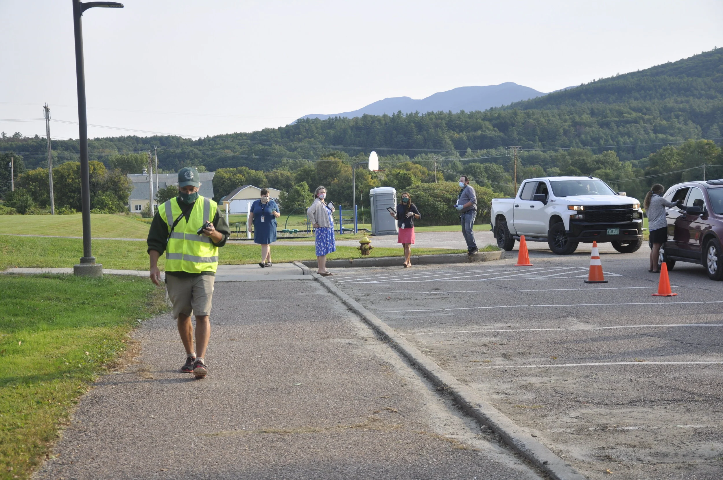   Principal Tom Drake oversees the dropoff area, radio in hand. Photo by Lisa Scagliotti.  